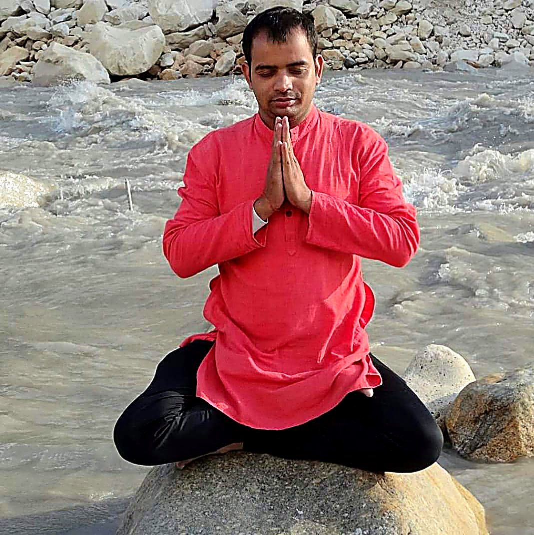 Dr. Vijay Ojha meditating by the river